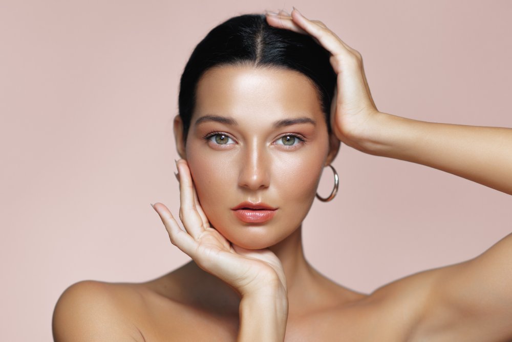 Close-up of woman with glowing skin surrounded by greenery - Medical Spa & Wellness By Michelle NP